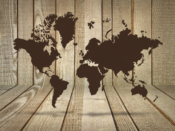 Карта світу коричневого кольору в кімнаті з дерев'яною стіною і підлогою
.  - Фото, зображення