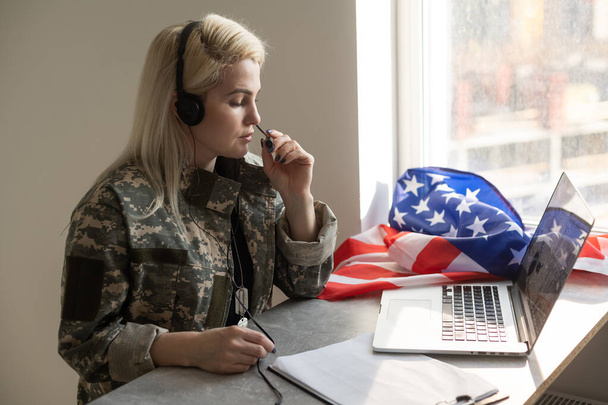 Pretty military woman making a video call - Фото, зображення