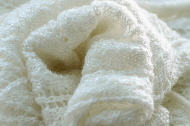 White knitted scarf. The concept of warm clothes for winter. - Fotó, kép