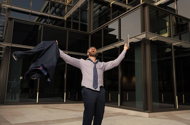 happy entrepreneur with laptop shouting celebrating business success outdoor feel free, freedom - 写真・画像