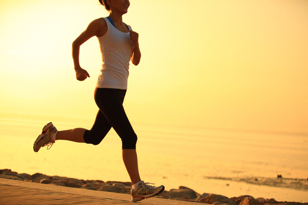 Runner athlete running at seaside. woman fitness silhouette sunrise jogging workout wellness concept. - Zdjęcie, obraz
