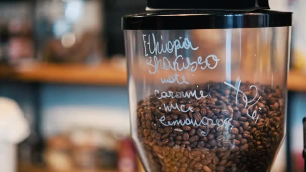 Coffee maker with coffee beans and inscriptions in a coffee house in Brasov, Romania - Footage, Video