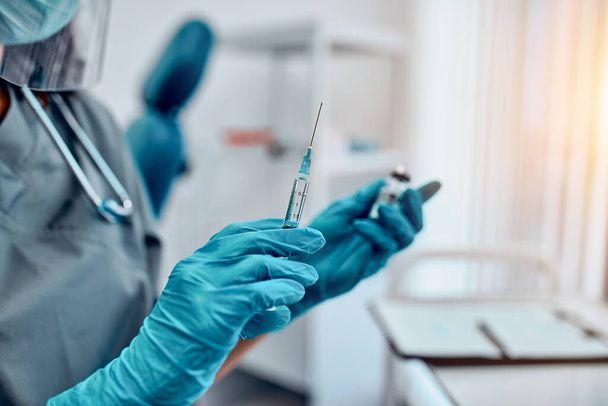 Cropped image of hands holding a covid-19 vaccine and a syringe. Vaccination and preservation and protection of health. - Foto, Bild