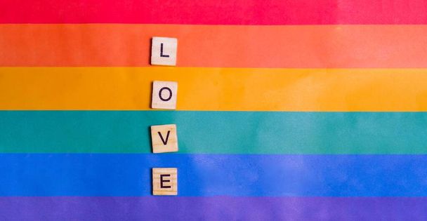 Love inscription with rainbow Flag. The concept of rainbow love. Human rights and tolerance. Poster, postcard, banner and background. - Foto, Imagem