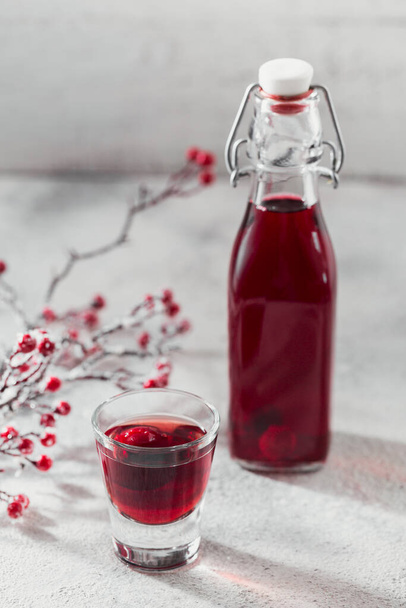 Homemade infused vodka, tincture or liqueur of red cherry - Foto, immagini
