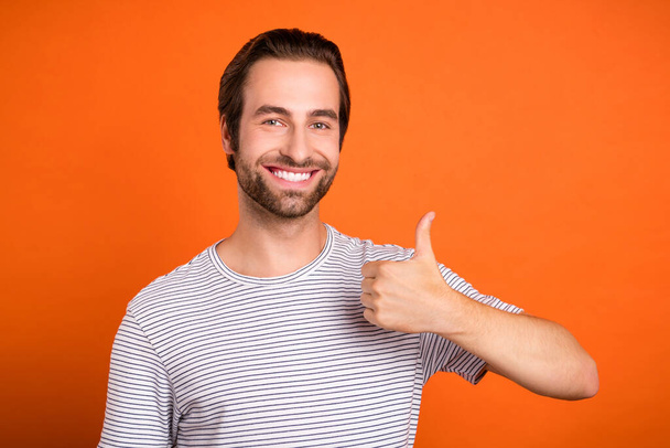 Photo of young man show finger thumb-up approval yes quality ads isolated over orange color background - Fotoğraf, Görsel