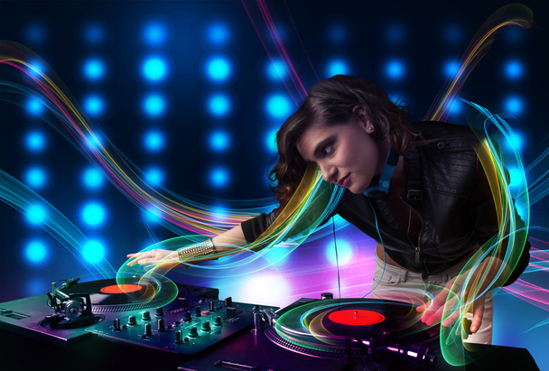 Young Dj girl mixing records with colorful lights - Fotoğraf, Görsel