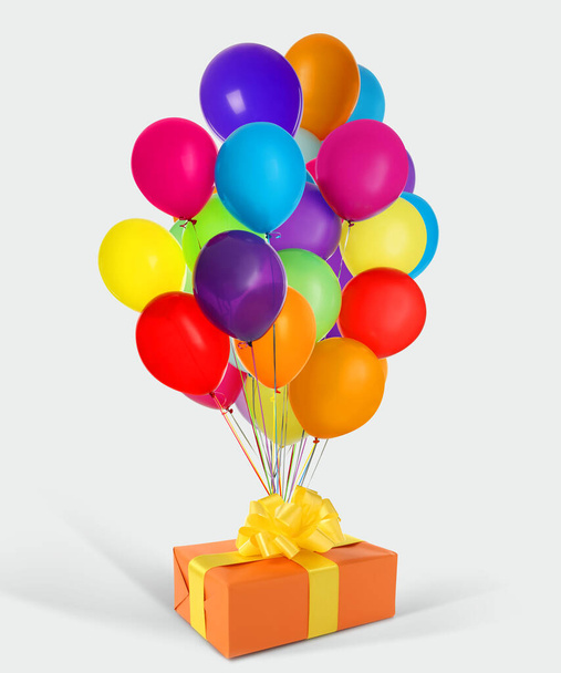 Beautiful gift box and bunch of colorful balloons on white background - Zdjęcie, obraz