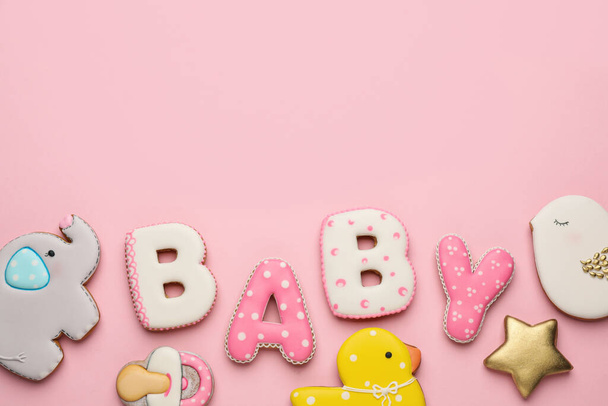 Word BABY and tasty cookies on pink background, flat lay. Space for text - Foto, afbeelding