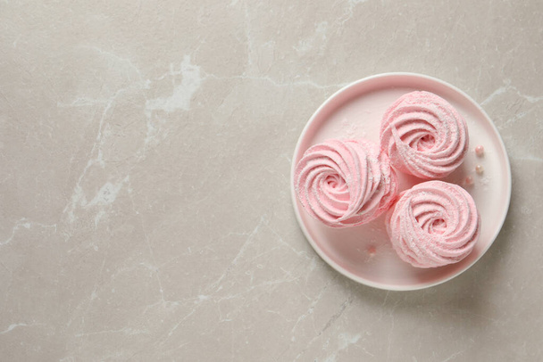 Delicious pink marshmallows on light grey table, top view. Space for text - Фото, зображення