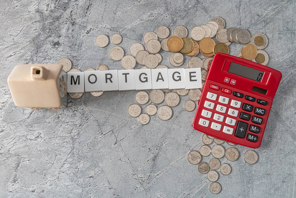 Красный калькулятор с ипотечным знаком - Концепция ипотечного кредитования - Фото, изображение