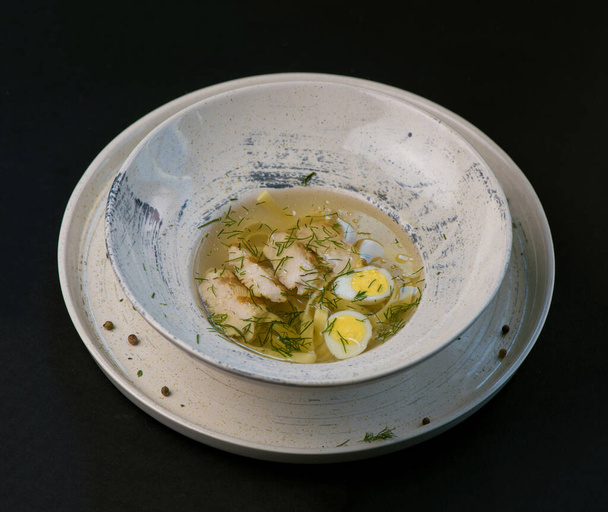 Chicken noodle soup - brothon a black background - Foto, immagini