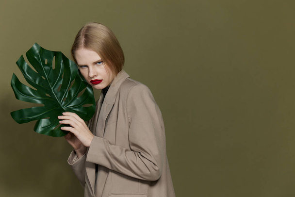 pretty woman green palm leaf coat bright makeup studio model unaltered - Fotoğraf, Görsel