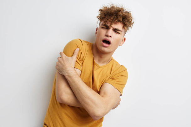 handsome young man in yellow t-shirts gesture hands emotions Lifestyle unaltered - Fotoğraf, Görsel