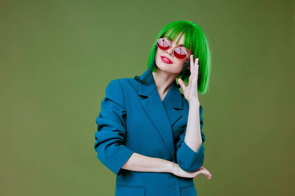 Frau mit grüner Perücke stylische Brille Mode posiert grünen Hintergrund - Foto, Bild