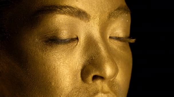 Closeup Of Ladys Face With Golden Skin On Black Background - Footage, Video