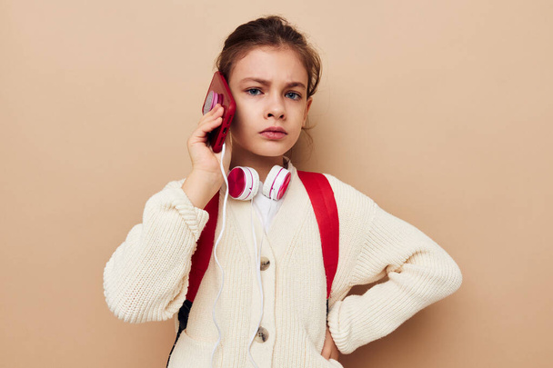 schoolgirl with headphones talking on the phone technology childhood - Foto, Imagen