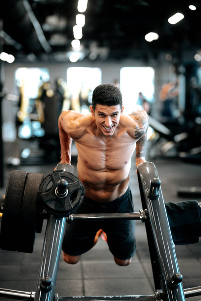 athletic healthy fitness man doing triceps workout at gym - Photo, image