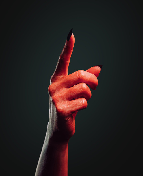 Demon hand with gesture pointing upward - 写真・画像
