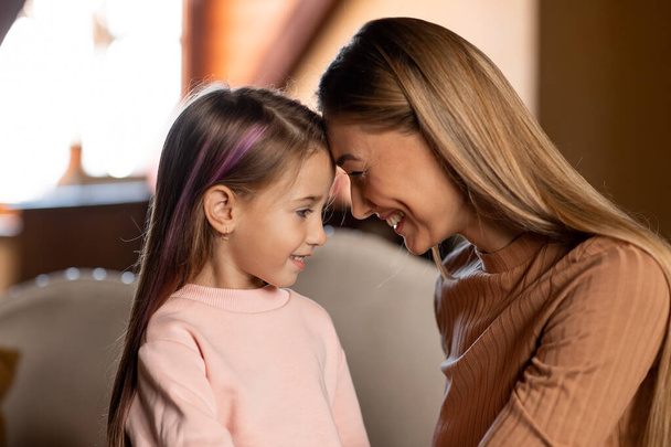 Portrait of happy woman and daughter spending time together - Photo, image