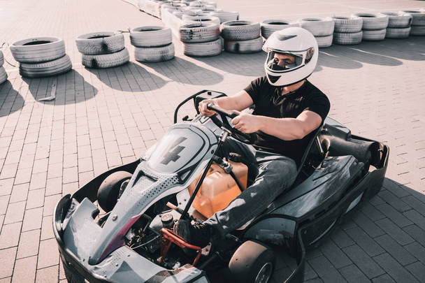 A young man drives a go kart at circuit - Zdjęcie, obraz