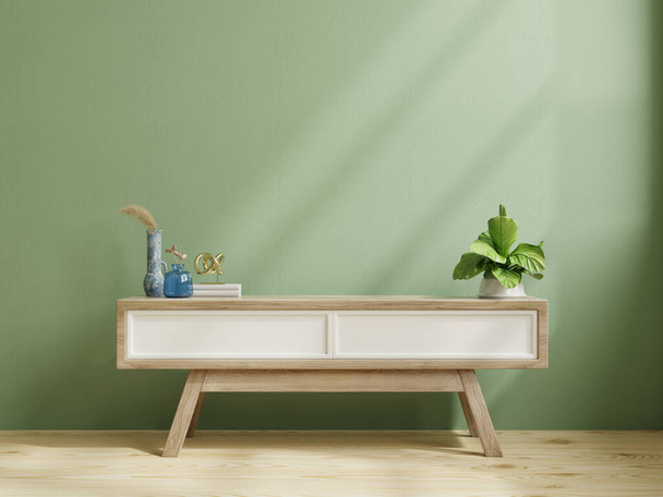 Moderne houten commode voor tv mockup in lege kamer met groene muur.3d rendering - Foto, afbeelding