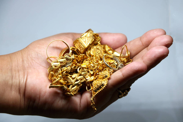 Women hand holding mix Gold jewelery (ornament) - Photo, Image