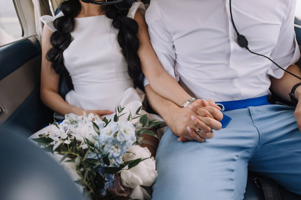 loving couple of newlyweds tenderly hold hands, close-up - Photo, Image