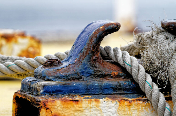 Close up of the boat bollard with a rope tied around it. Connection visual concept as boat tied and linked to the pontoon - Photo, Image
