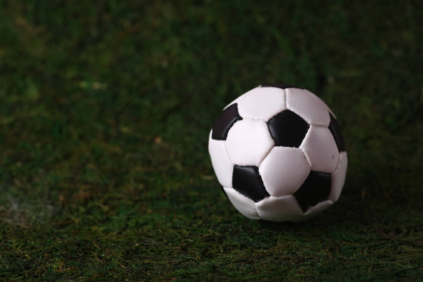 Sport concept - soccer ball isolated on green grass background. Image contains copy space - Foto, Imagem