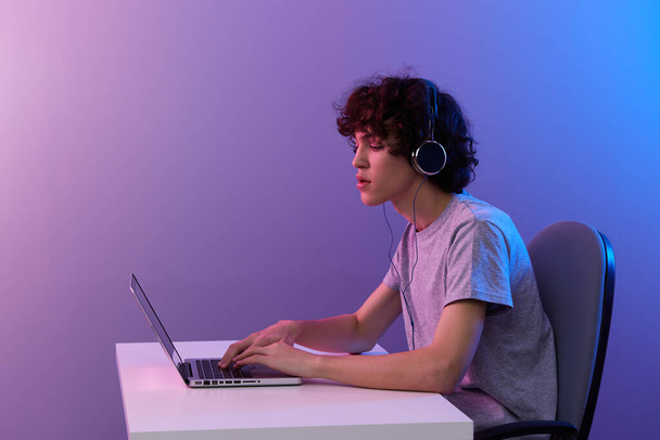 man in headphones in front of laptop entertainment Lifestyle technology - 写真・画像