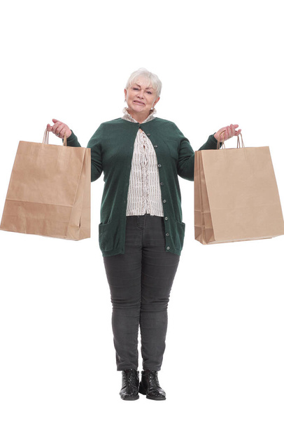 Front view portrait of pretty mature lady carrying shopping bags - Fotó, kép