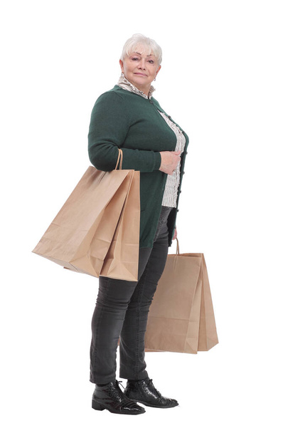 Smiling senior woman with shopping bags over white background - Photo, Image