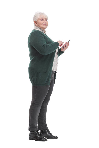Side view of happy modern middle age woman wearing jeans with smart phone - Photo, image