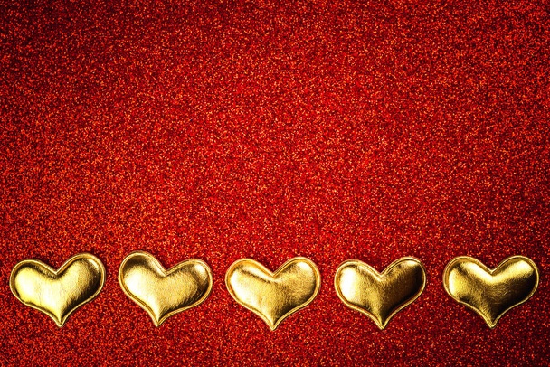 Valentines day flat lay background with hearts on a red glitter. Top view and copy space - Foto, immagini
