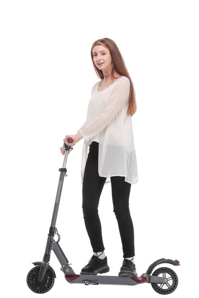 Young happy woman is standing a back near her kick scooter - Фото, зображення