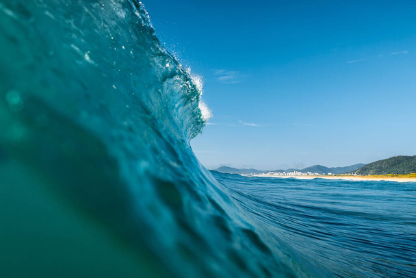 Surfing wave in Atlantic ocean. Blue glassy barrels and clear sky in Brazil - Photo, Image