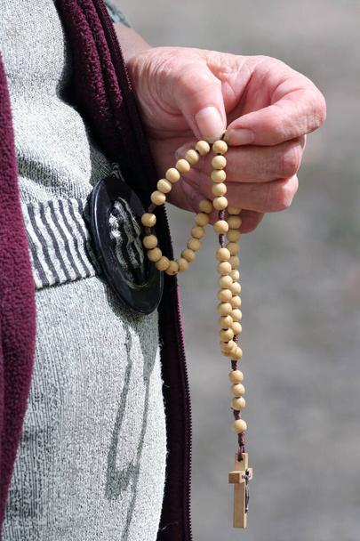 Hand-carved Roman Catholic rosary beads. Woman praying The Mystery of the Holy Rosary. La Roche-sur-Foron. France. - Photo, Image