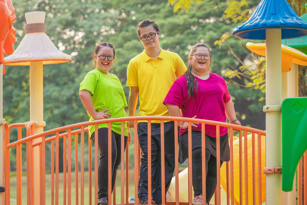 group of asian people friends with autistic or down syndrome having fun playing together at playground in park for recreation - Foto, Imagem