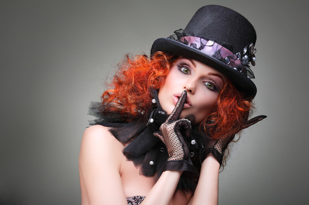 Portrait of beautiful sexual redheaded girl in a black hat on a grey background. Accessories. - Foto, imagen