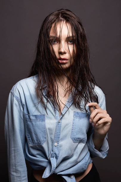 Young woman in denim shirt. Beautiful Girl with wet hair - Фото, изображение