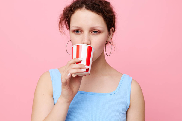 emotional woman from disposable glasses drink pink background - Foto, Bild