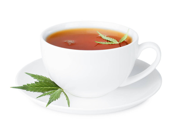 herbal tea with cannabis leaves in a white cup on an isolated white background - Photo, Image