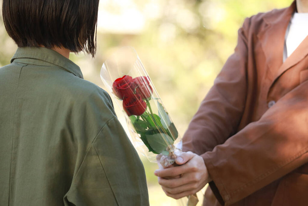  asian man giving roses to woman  - Photo, Image