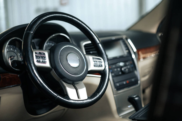 Modern car interior, steering wheel and dashboard - Fotografie, Obrázek