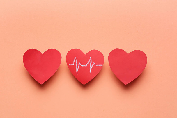 Red hearts and cardiogram drawing on color background. Donation concept - Photo, Image