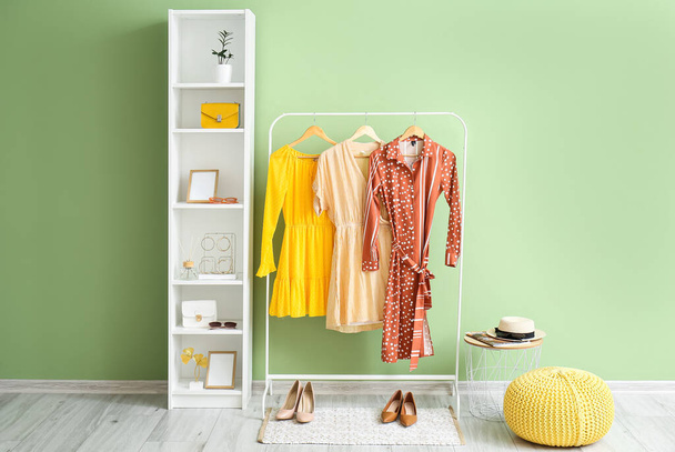 Interior of room with hanger and shelf unit near color wall - Fotoğraf, Görsel