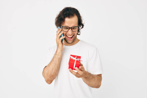 Cheerful man talking on the phone gift box isolated background - Φωτογραφία, εικόνα