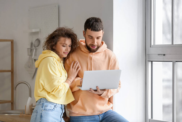Modern young couple with laptop at home - Photo, image