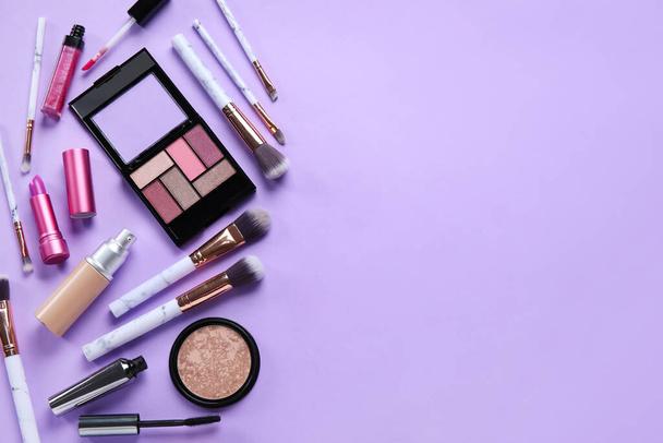 Different makeup products on purple background - Foto, Imagem